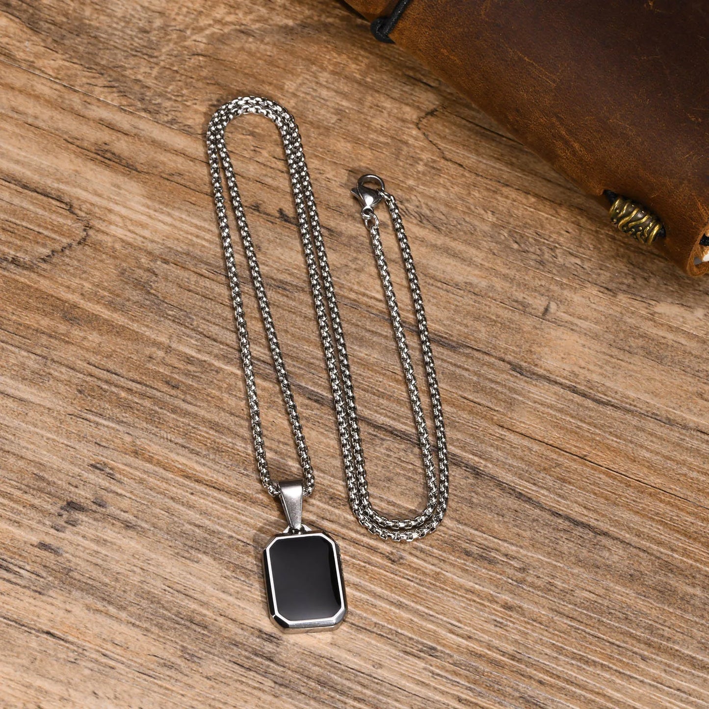 Silver and gold necklace with silver and black pendant