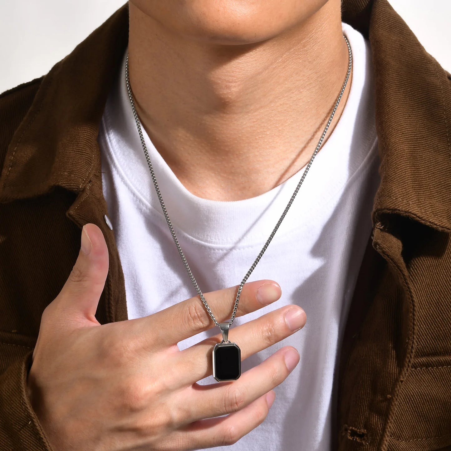 Silver and gold necklace with silver and black pendant